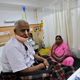 62-year-old Abdul Kayum sits on a hospital bed after doctors lopped part of his jaw, gums and teeth to stop cancer from spreading in his mouth, in New Delhi